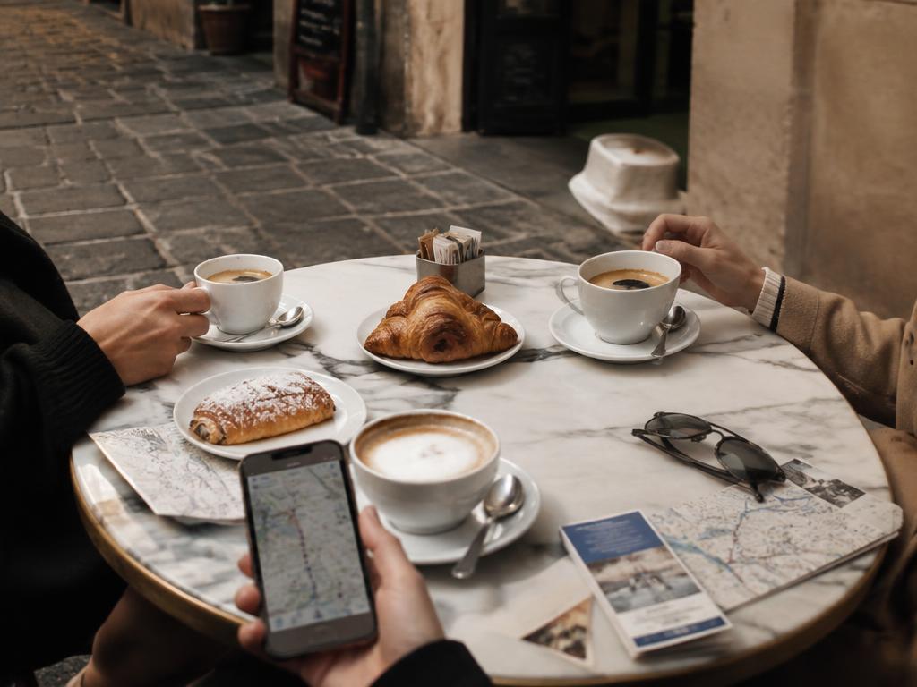 Friends reviewing their trip together around a table